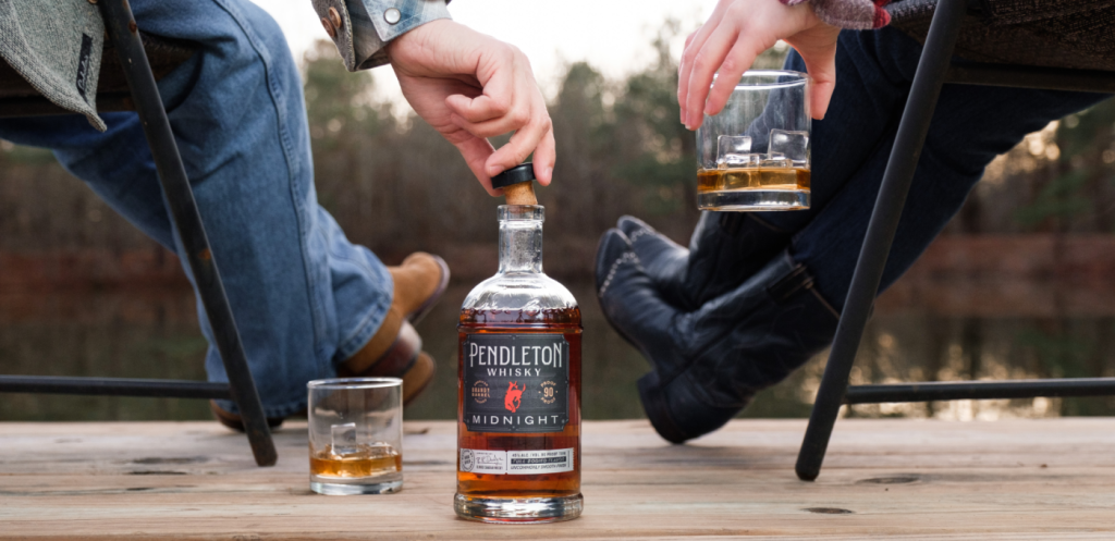 A cowboy and cowgirl drinking Pendleton Whisky Midnight